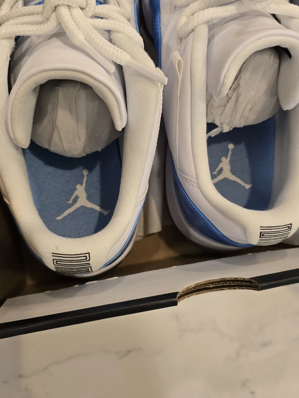 Air Jordan 11 Low Retro White and University Blue Sneakers